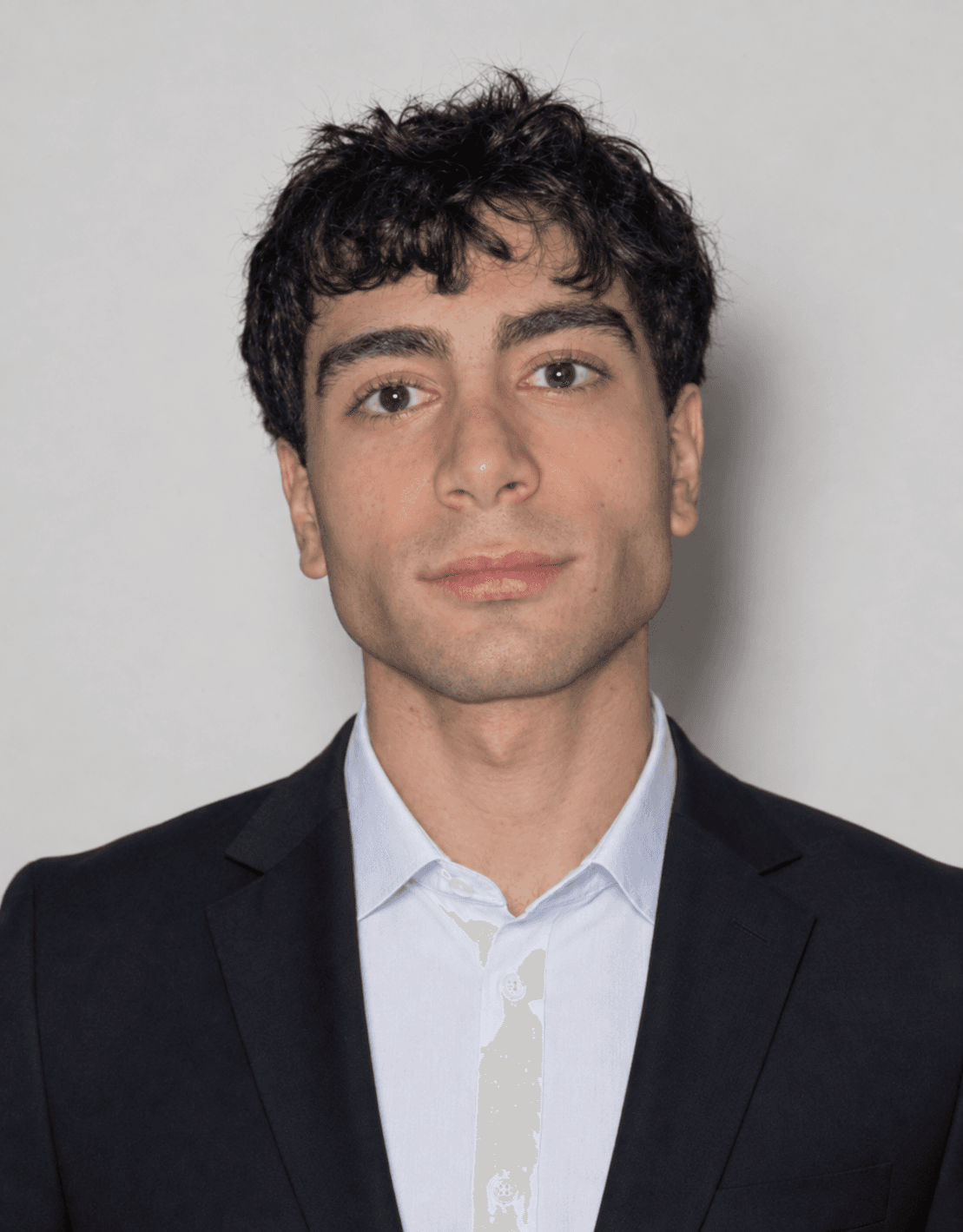 Hadi Alhoussayni in a dark suit and light blue shirt